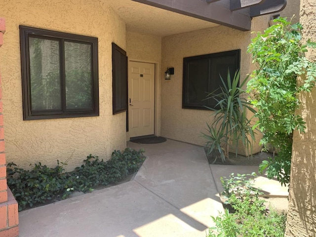 property entrance featuring a patio area