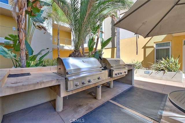 view of patio with an outdoor kitchen and area for grilling