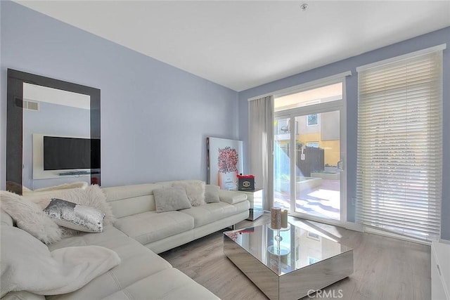 living room with visible vents and wood finished floors