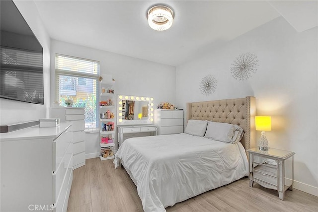 bedroom featuring light wood-style flooring and baseboards