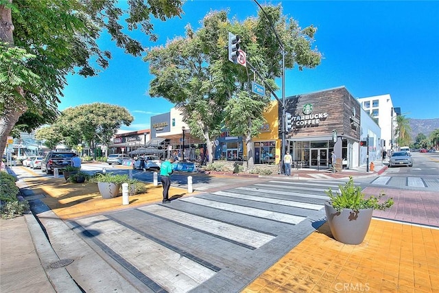 view of street with sidewalks, street lighting, and curbs