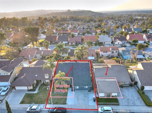 drone / aerial view featuring a residential view and a mountain view