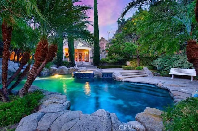 view of pool at dusk