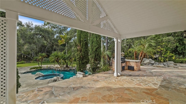 view of patio featuring an in ground hot tub