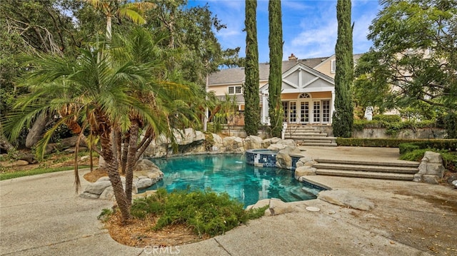 view of pool with french doors