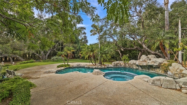 view of pool with an in ground hot tub