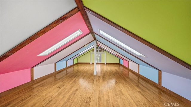 bonus room with lofted ceiling with beams and light hardwood / wood-style floors