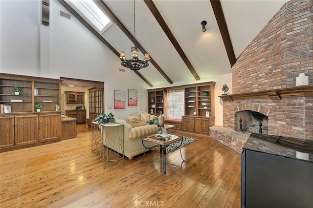 living room with beam ceiling, a skylight, high vaulted ceiling, and light wood-type flooring