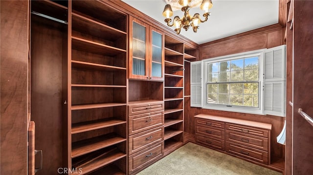 walk in closet with carpet floors and a chandelier