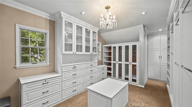 walk in closet with light carpet, a chandelier, and lofted ceiling