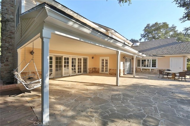 back of property with french doors and a patio