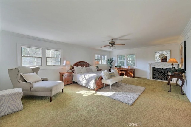 carpeted bedroom with multiple windows, ceiling fan, and ornamental molding