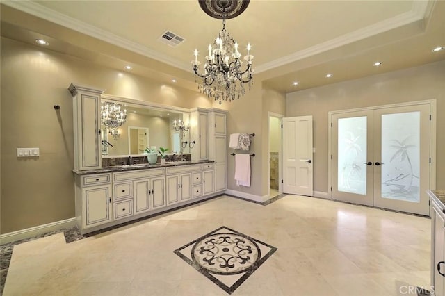 bathroom featuring a notable chandelier, vanity, crown molding, and french doors