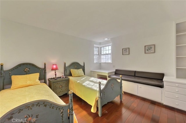 bedroom with dark wood-type flooring