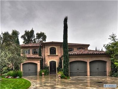 mediterranean / spanish-style house featuring a garage