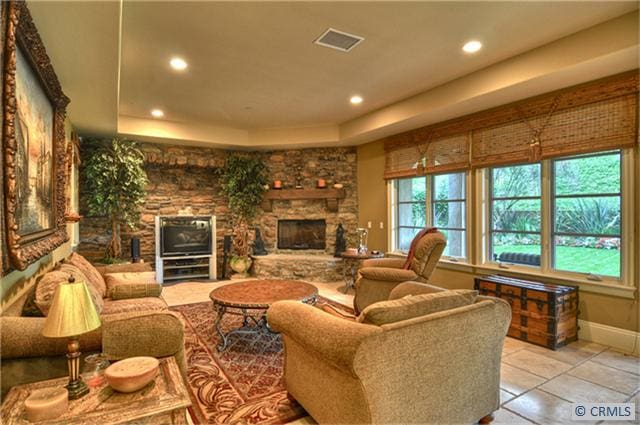 living room with a stone fireplace