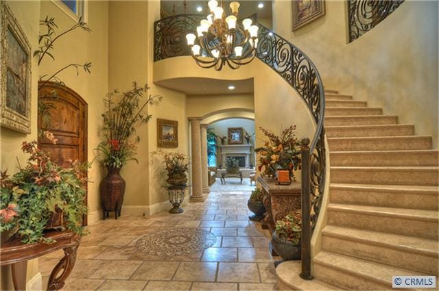 entryway featuring a high ceiling and a notable chandelier