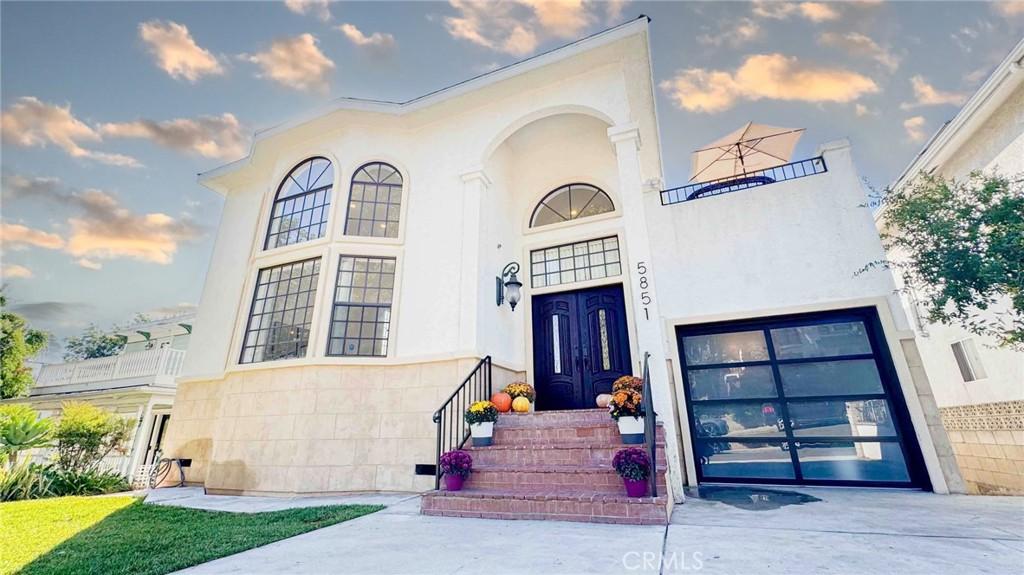 exterior entry at dusk with a garage