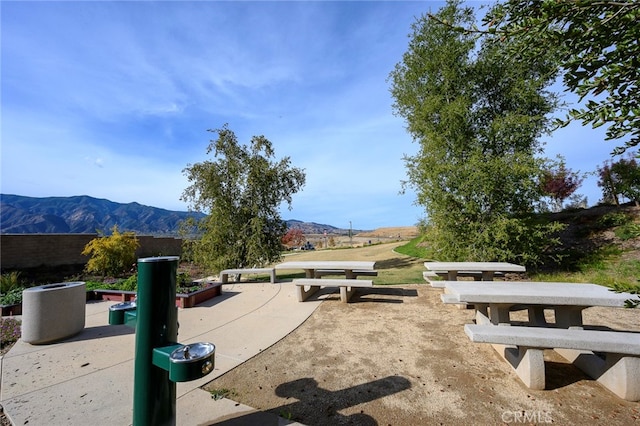 surrounding community with a patio area and a mountain view