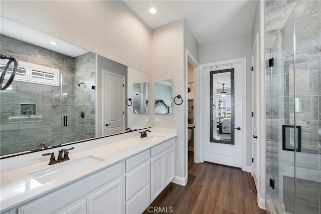 bathroom featuring hardwood / wood-style floors, an enclosed shower, vanity, and toilet