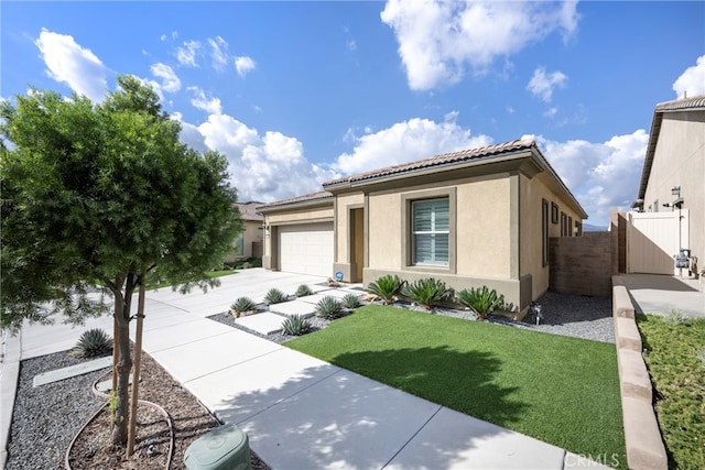 view of front of property with a garage and a front yard