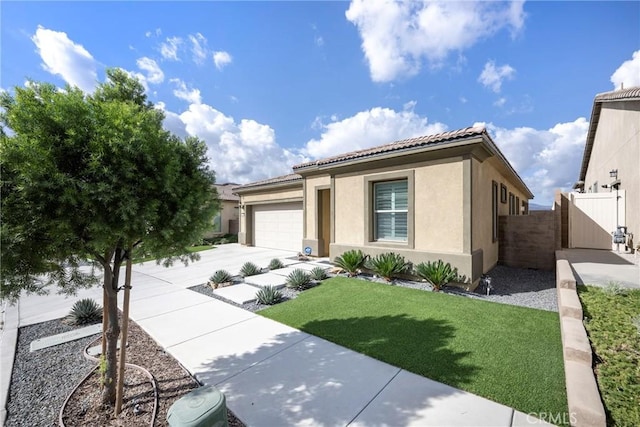 24185 Sprout Dr, Corona, CA 92883 - view of front of property featuring stucco siding, fence, a tiled roof, driveway, and a garage