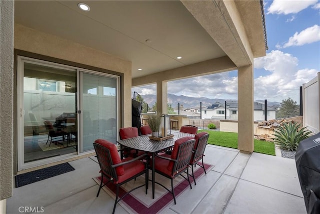 24185 Sprout Dr, Corona, CA 92883 - view of patio featuring outdoor dining area, fence, and a mountain view