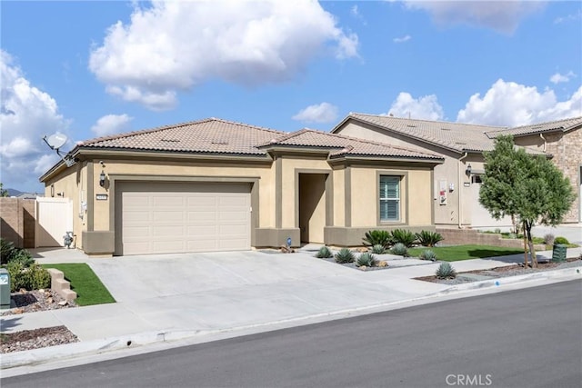 24185 Sprout Dr, Corona, CA 92883 - view of front of property featuring driveway, stucco siding, a tile roof, and an attached garage