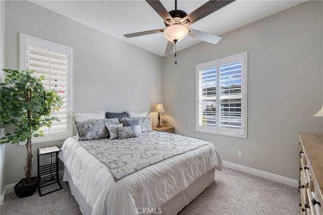 bedroom with ceiling fan and light colored carpet