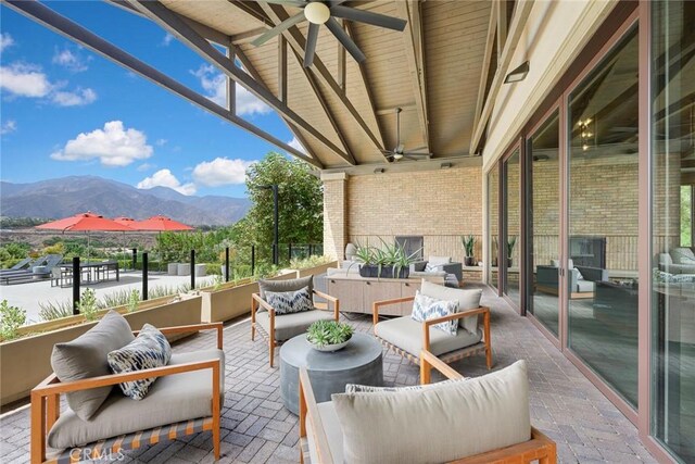 view of patio / terrace with ceiling fan, a mountain view, and an outdoor hangout area