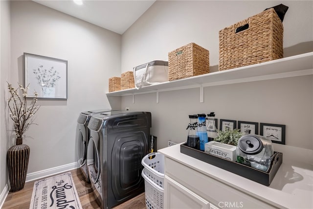 laundry room with washing machine and dryer and wood-type flooring