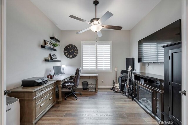 office with hardwood / wood-style flooring and ceiling fan