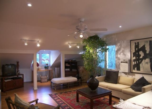 living room featuring hardwood / wood-style flooring, ceiling fan, and cooling unit