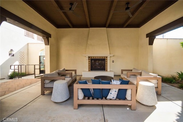 view of patio with an outdoor living space with a fireplace and ceiling fan