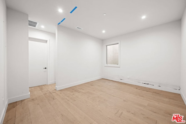 unfurnished room featuring light hardwood / wood-style floors