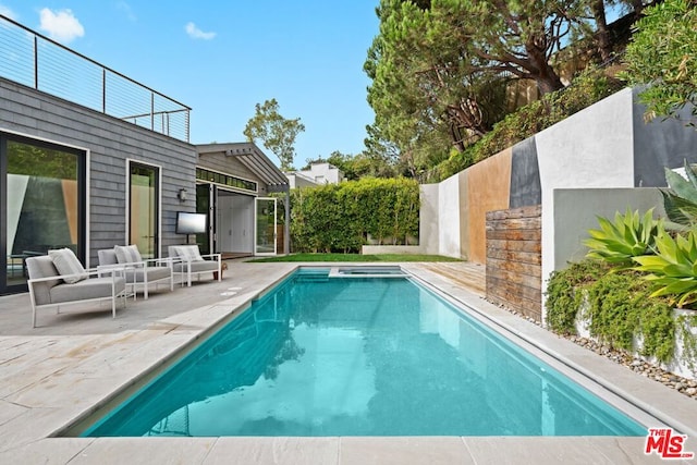 view of swimming pool with outdoor lounge area and a patio