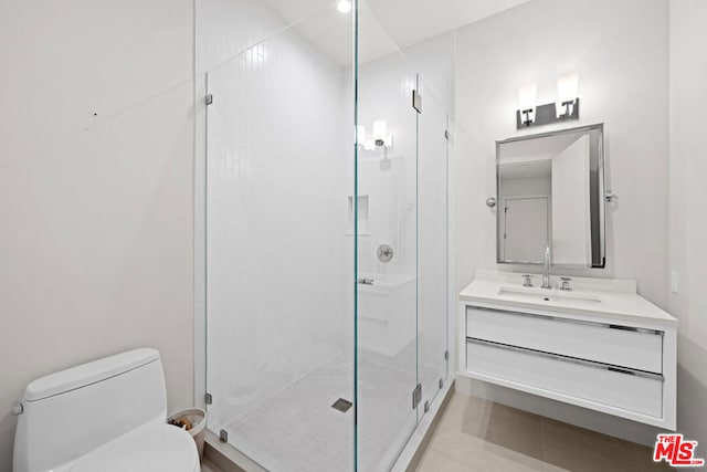 bathroom featuring toilet, vanity, and walk in shower