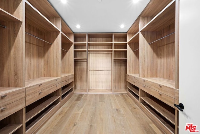 spacious closet featuring light hardwood / wood-style flooring