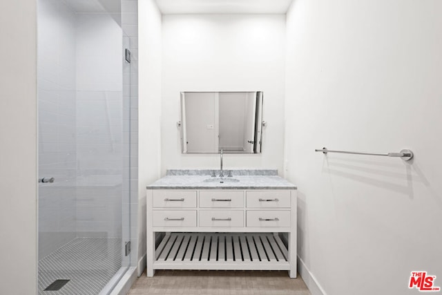 bathroom with an enclosed shower and vanity