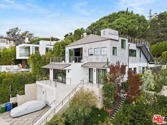 rear view of property with a balcony