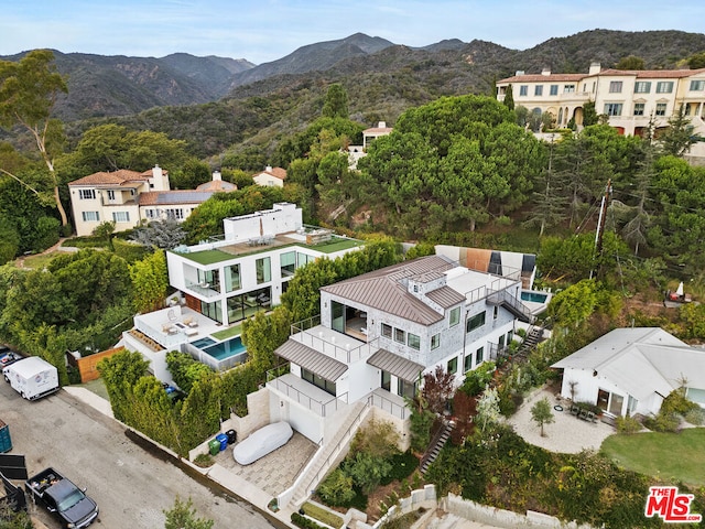 birds eye view of property with a mountain view