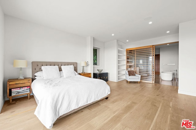 bedroom with light hardwood / wood-style floors