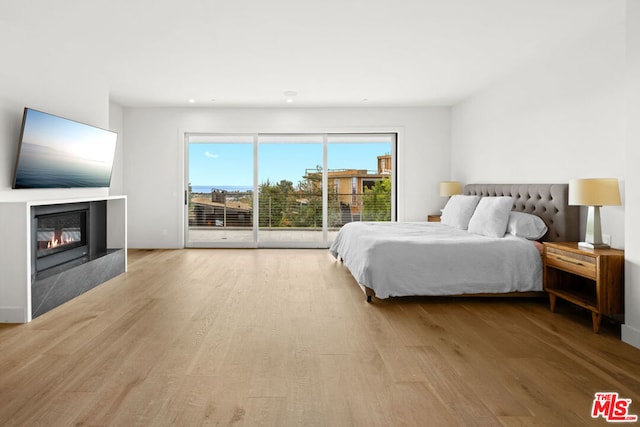 bedroom featuring light hardwood / wood-style floors and access to outside