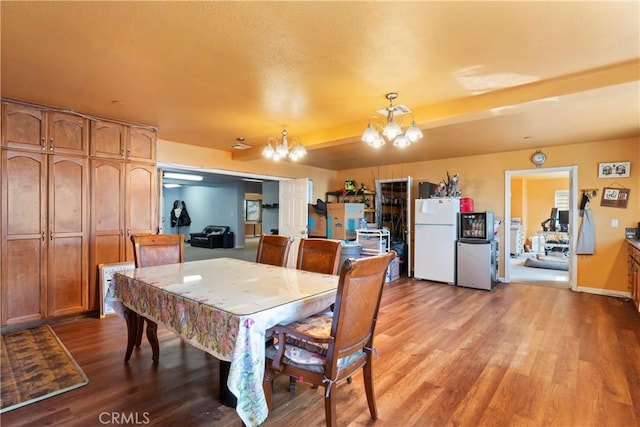 dining room featuring hardwood / wood-style flooring and an inviting chandelier