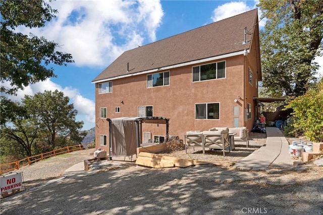 rear view of house featuring an outdoor living space