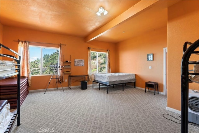 bedroom with carpet flooring and beam ceiling