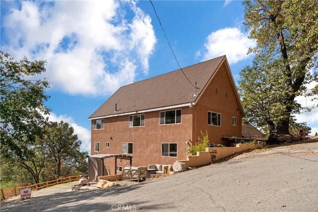 rear view of house with outdoor lounge area