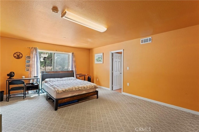 bedroom with carpet and a textured ceiling