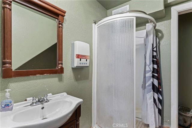 bathroom featuring a shower with curtain, tile patterned floors, and sink