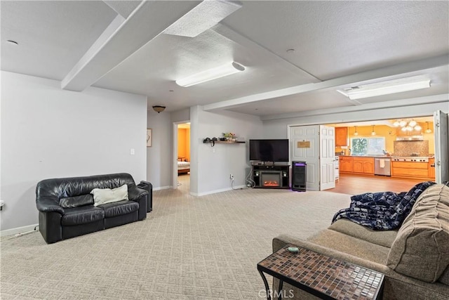 living room featuring carpet flooring, a textured ceiling, and a fireplace